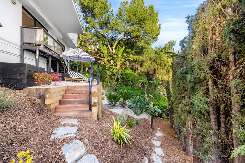 Un moderno jardín familiar con una remodelación de una casa antigua
